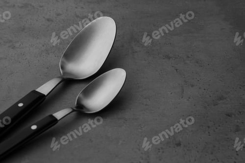 Preview: Clean empty table spoons on grey background, space for text