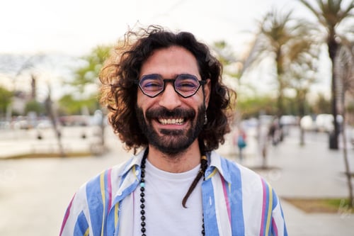 Preview: Smiling Man with Curly Hair Outdoors Portrait