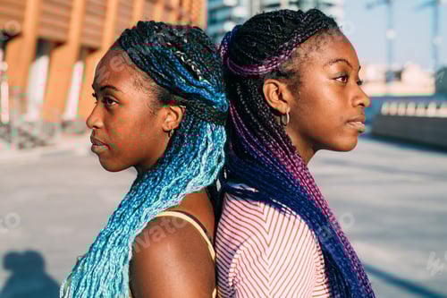 Preview: Two young black sisters posing back to back