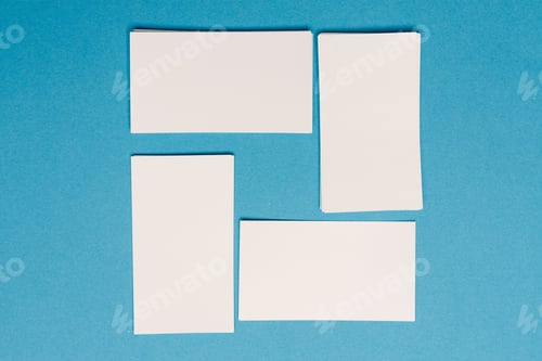 Preview: white business cards mockup placed randomly on the office desk