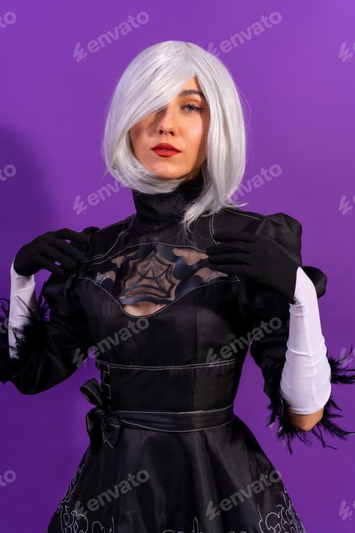 Preview: Portrait of cosplay woman in a black costume and a white wig in studio on a purple background