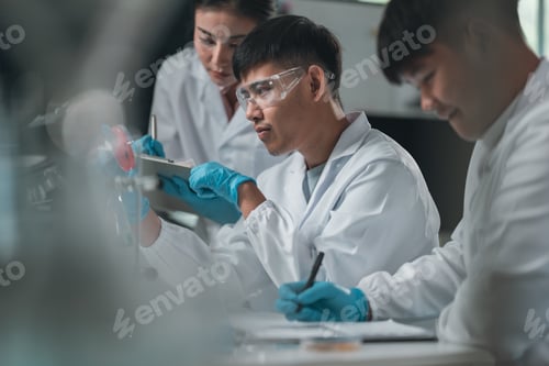 Preview: Scientist examining biological samples under a microscope in medical research laboratory