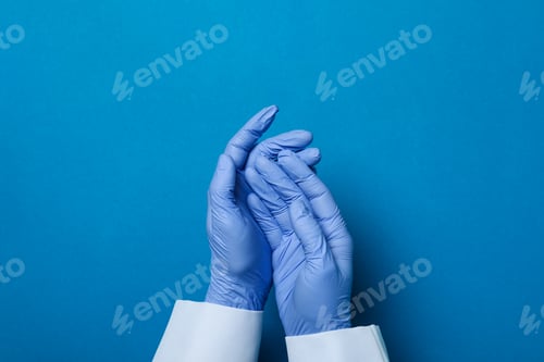 Preview: Doctor hands in medical gloves on blue background
