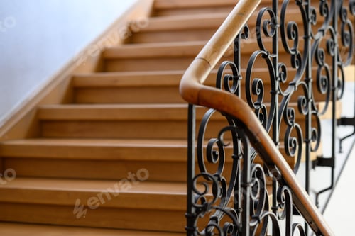 Preview: Close-up of a set of ornate wooden stairs, leading up to the entrance of a house