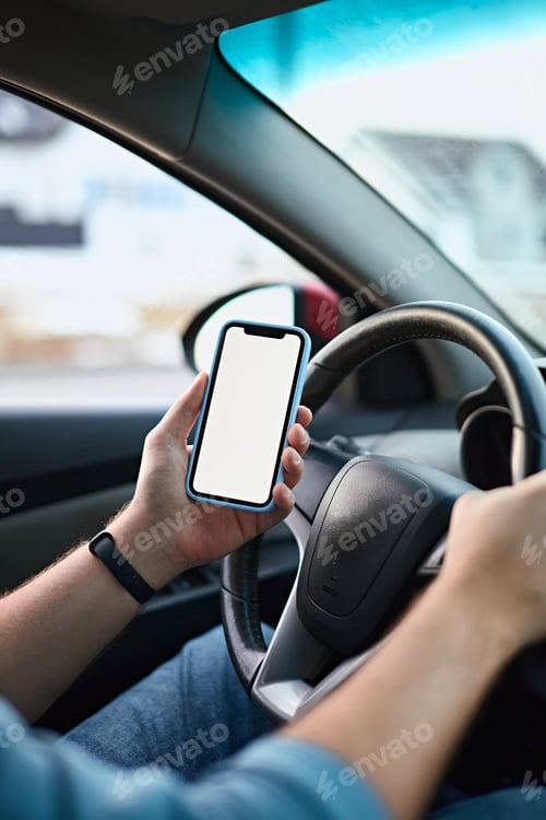 Preview: Close up Hands of unrecognizable man driver using white screen mockup mobile phone while driving