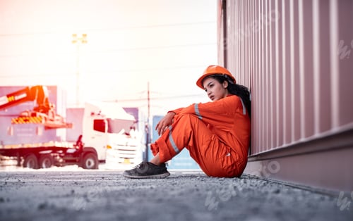 Preview: Engineer or worker sit close to cargo container look like tired after work in workplace area for lon