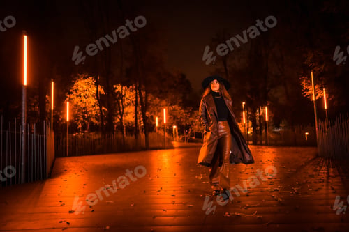 Preview: Girl with a hat walking calmly through a park on a winter night