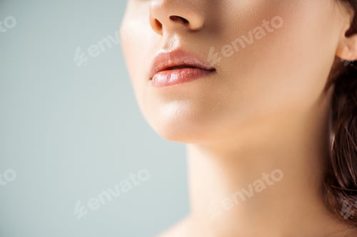 Preview: cropped view of young woman with shiny lips on grey background