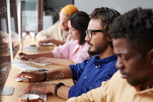 Preview: Row of business people working with computers