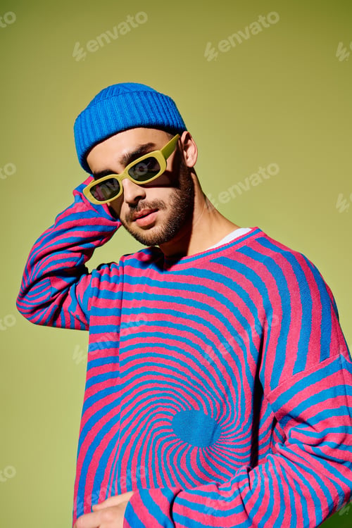 Preview: Handsome young man showcases vibrant fashion sense against a striking green backdrop