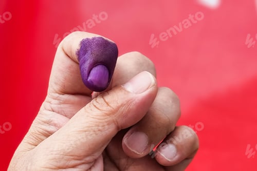 Preview: Closeup of purple indelible ink on index finger. Used in election in Malaysia to prevent fraud.