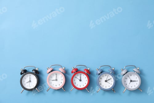 Preview: Classic multicolored alarm clocks with on a blue background