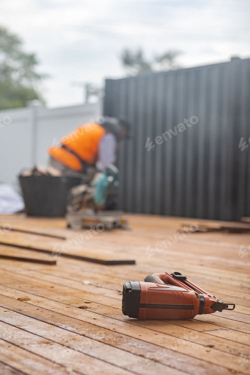 Preview: wooden floor with a electric sander and a man working in the background