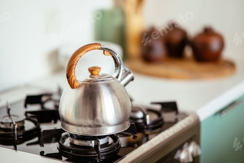 Preview: Kettle on the gas stove. Interior of modern kitchen