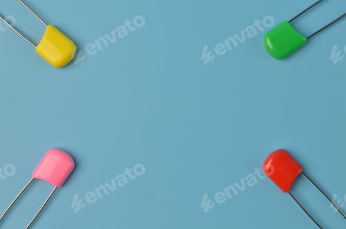 Preview: Colorful safety pins isolated on a blue background. Copy space for the text.