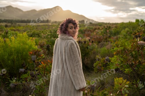 Preview: Portrait of woman standing in nature during fall