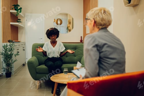 Preview: An african american woman is sitting at the mental health clinic