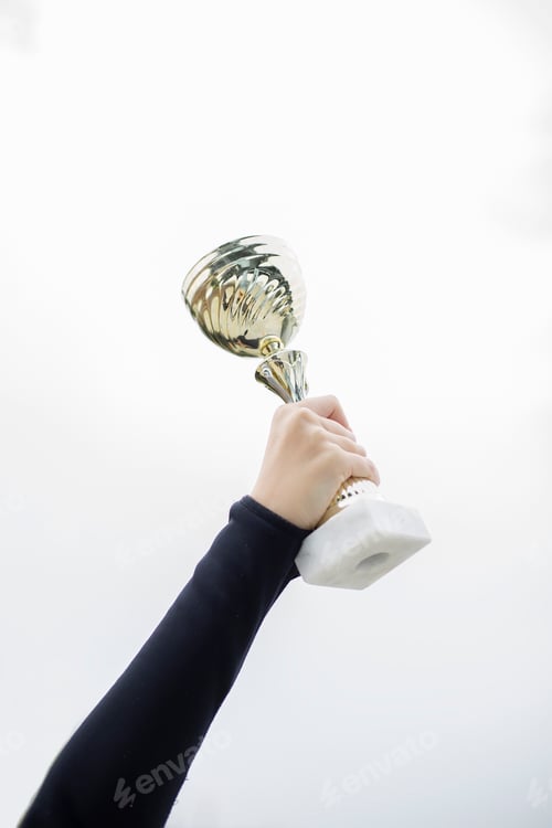 Preview: Sport woman holding a trophy