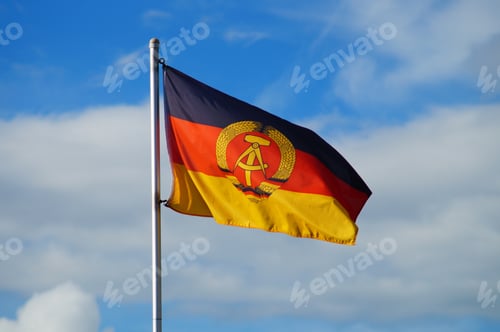 Preview: Flag of the GDR flies in a garden