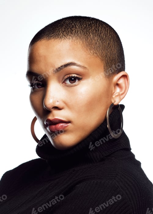 Preview: Studio shot of an attractive young woman posing against a grey background