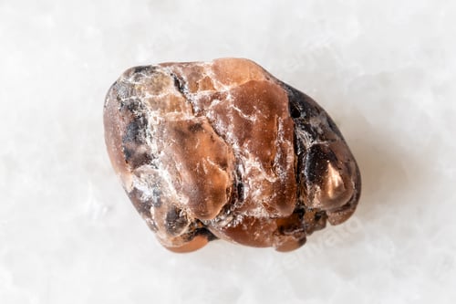 Preview: sample of rough triplite mineral on white marble