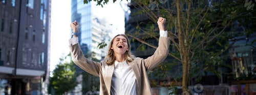 Preview: Happy businesswoman scream of joy, raise hands up in celebration, cheering gesture, achieve goal