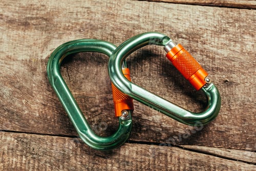Preview: Climbing rope and carabiner on wooden board