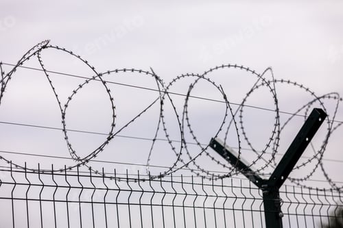 Preview: Barbed wire on the sky background. selective focus. metal wire