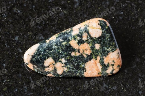 Preview: sample of tumbled gabbro mineral on black granite