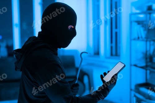 Preview: Thief using a smartphone during a break-in