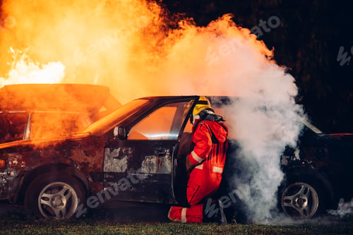 Preview: Firefighter in Full Protective Gear. Heroic Fireman Combats Intense Blaze with Life-Saving Equipment