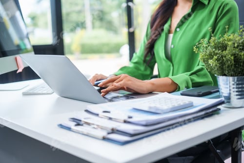 Preview: An businesswoman sits at table in her office, working as an accountant uses a computer smile,
