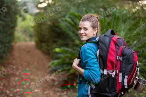 Preview: Woman Hiking Through A Forest In The Countryside