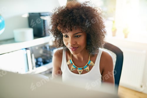 Preview: Attractive young woman working on a computer