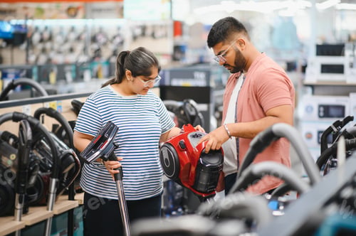Preview: Indian Couple choosing vacuum cleaner, electronics store