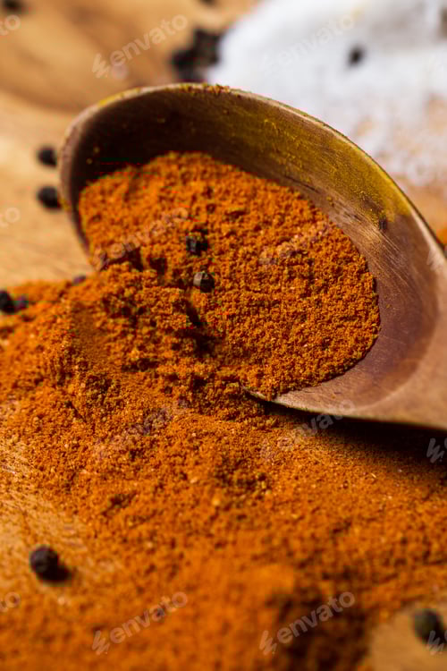 Preview: Spoon and heap of spices on the table