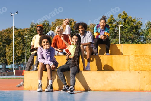 Preview: Multiracial group of young friends bonding outdoors