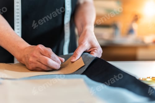 Preview: Fashion designer putting pins into pattern and fabric
