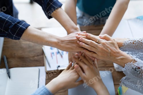 Preview: Group of young businessmen in Asian suits clasping hands Stack your hands to brainstorm to complete