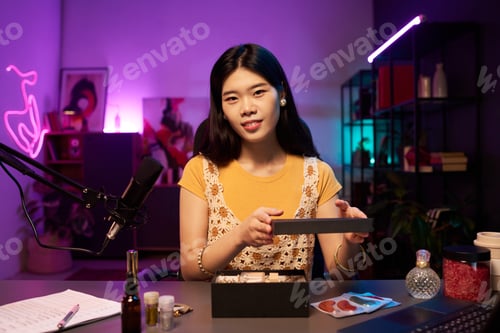 Preview: Portrait of Asian Young Woman Presenting Beauty Products