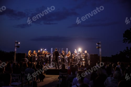 Preview: Musical ensemble performing live concert at night
