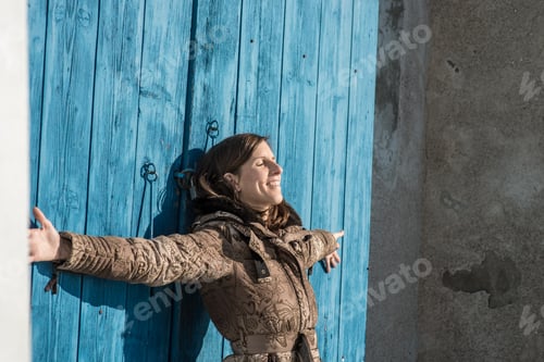 Preview: Young woman enjoying warm winter sun