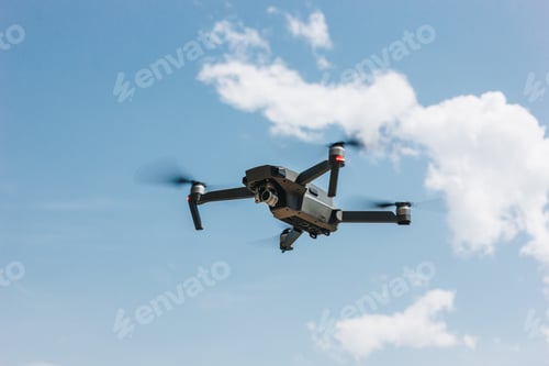 Preview: controlled modern drone flying in blue sky