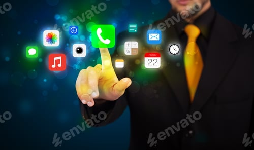Preview: Businessman Pressing Colorful Mobile App Icons With Bokeh Background