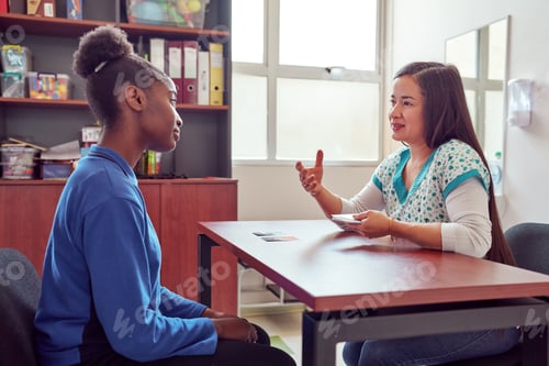 Preview: speech therapist working with playing cards with black teenage secondary school student