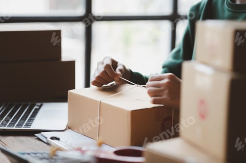 Preview: An woman tying a parcel to a customer's box, she owns an online store, she packs and ships through a