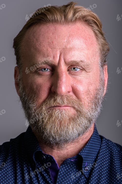 Preview: Face of mature bearded man in gray background