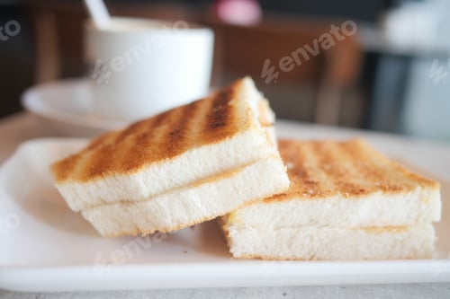 Preview: top view of peanut butter and a bread on plate on black background