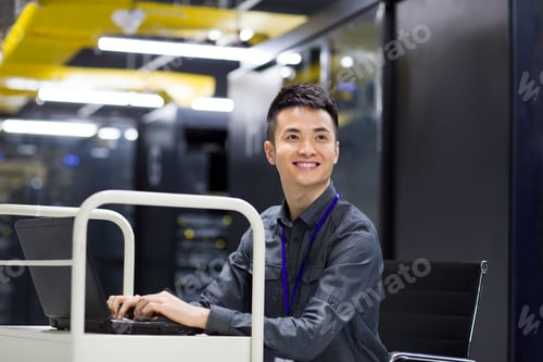 Preview: Businessman using laptop in computer room