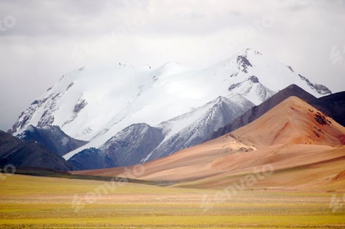 Preview: Tranquil landscape featuring a rolling mountain range in the background and a lush, green field